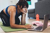 Sporty Woman Looking For Workout on Laptop