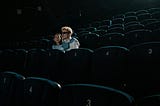Couple sitting in theater.