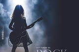 magazine cover featuring photo of young girl holding an electric guitar backlit and surrounded by smoke on a dark stage. Her silhouette is visible but very few details of her face, body or clothes can be seen. REGIS
 UNIVERSITY MAGAZINE
 VOLUME 31 ISSUE 2 | FALL/WINTER 2023
 REGIS.EDU
 LET THERE BE
 ROCK
 p.18
 REGIS FOOTBALL
 HERO GETS BUSTED
 p.32
 CONTINUING REGIS’ SERVICE MISSION
 p. 24
 CARING FOR GOD’S GREEN EARTH
 p.12