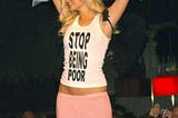 Paris Hilton wearing a tank top that reads “Stop Being Poor.”