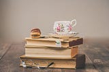 An image of a tea cup on a stack of books