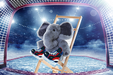 A stuffed elephant on a chair, wearing hockey stakes, in a hockey net