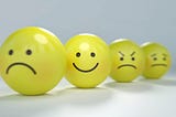 Emoticons with frown, smile, angry face, worried face