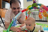John and his son doing tummy time