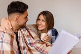 Medium shot couple being affectionate indoors