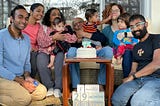 Picture of my family in North Carolina for my father’s 73rd birthday. Picture contains my family, my sister’s family, and my parents. We’re all sitting on a couch. It’s slightly chaotic because babies are hard to control.