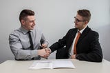 Businessmen shaking hands to signify transparency.