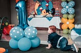 Photo by Cleyder Duque: https://www.pexels.com/photo/baby-in-blue-denim-jacket-crawling-on-floor-near-the-balloons-3653948/