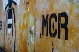 Street art of the Manchester bee and the word MCR