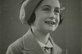 Photo of Anne Frank in 1937, smiling in a hat