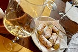 a vineyard tasting of white wine and delicious canoli on a table