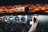 A pilot flying an aircraft and adjusting flight controls