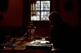 A man sits alone at a table for five