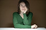 A woman wearing a green long sleeved shirt