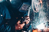A worker welding in a factory.