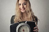 Skinny Woman Holding a scale