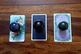 A spread of three cards, one each from the Unfolding Path, Radiant Waite and Ethereal Visions tarot decks with corresponding crystals of Sodalite, Black Obsidian and Green Aventurine respectively. Intuitively choose a card or crystal and head to your reading to discover the blessings that await you.
