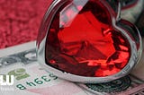 heart-shaped ring and fifty dollar bill
