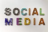 The words “Social Media” spelled out in colorful patterned 3D letters on top of a white background.