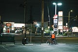 Saw this guy waiting under the lights for a good while around 11 PM — even after a bus had come through. || Photo by author