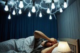 How should I position my source of light for a timely sleep?