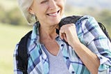 Happy senior woman enjoying a country walk