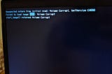 Photo of my laptop failing to boot, “failed to load image”, “Volume Corrupt”