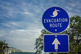 Evacuation Routes are clearly defined by signs. Know your best route for your area before you need to use it. Photo from Adobe Express Professional Collection.