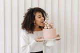 woman holding and eating cake