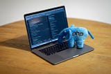 A laptop with a blue elephant with the php logo