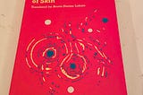 The cover of The Dark Side of Skin by Jeferson Tenorio is a vivid red with swirls of an abstract image in blue and yellow, perhaps making a female body. The book was translated by Bruna Dantas Lobato.