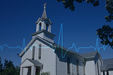 church in the background with an ekg line running across the screen