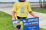 My son Luke holding a sign at the JDRF One Walk in Tampa, Florida