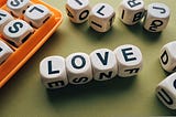A Boggle game with the letter blocks spelling out “LOVE.”