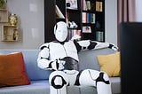 A white android robot relaxes comfortably on a living room couch