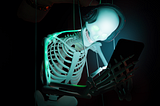 Skeleton with headphones od black background staring into a phone