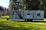 A very moldy metal trailer with the words “Sheriff” painted on the side.