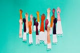 Colorful paper cutouts of raised arms in various skin tones, symbolizing diversity and inclusion, against a teal background. The bottom of each paper arm features cutouts of hearts and the word “CARE.”