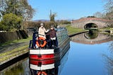Photo of crew of hire narrowboat moored on canal. 

Photo use by permission and courtesy of Time2Geaux.