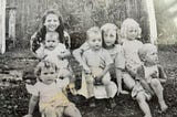 Old black and white photo from the 1940s showing Appalachian children posing together.