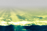 Neural rendition of a mountain top, unmasked from behind densely clouded skies, masked by obscure sun rays, with yellow-blue colourization adding to the esoteric or mystical feeling.