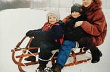 My mom, me and my brother sledding