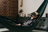 Millennial sits in hammock contemplating existential dread during 2020 quarantine