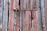 Rustic barn siding with red and gray hues