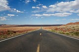 A picture of a straight road fading in the horizon