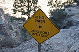 A sign on the Centennial trail that reads: Do Not Enter, Dangerous Overlook.