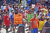 Protesters with banners like “Japan Fukushima Poisons Pacific” during march. Photo by Jonacani Lalakobau.