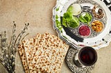 Passover seder plate with traditional food, matzah and wine