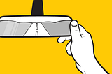 An illustration of a hand adjusting a rearview mirror