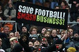Fans of German football team St Pauli show their dismay at the influence of big business on football prior to a match against FC Kaiserslautern in Hamburg with a banner saying: “Save football! Smash Business!”
